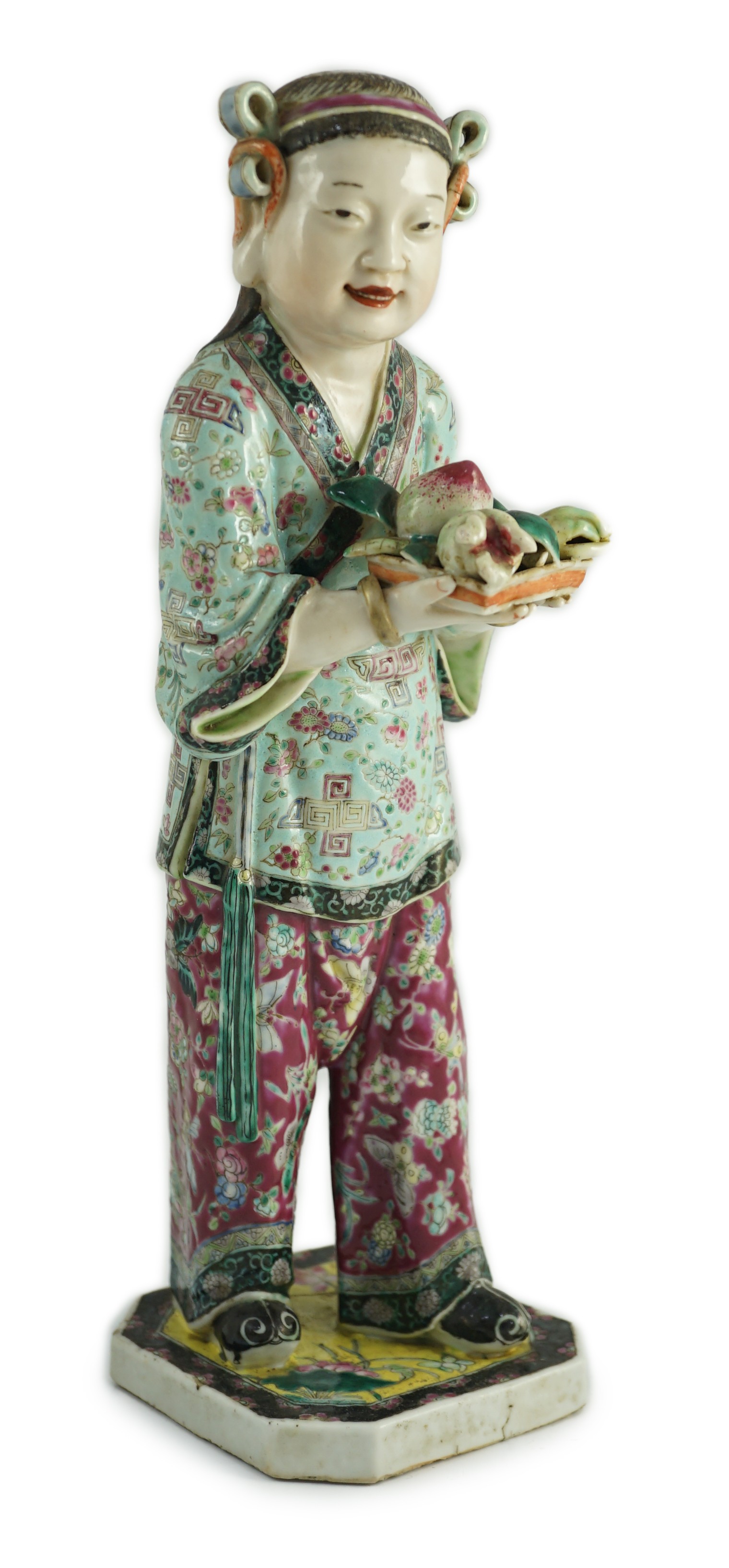 A Chinese enamelled porcelain figure of a boy attendant, early 20th century, 30.5cm high, base broken and re-glued